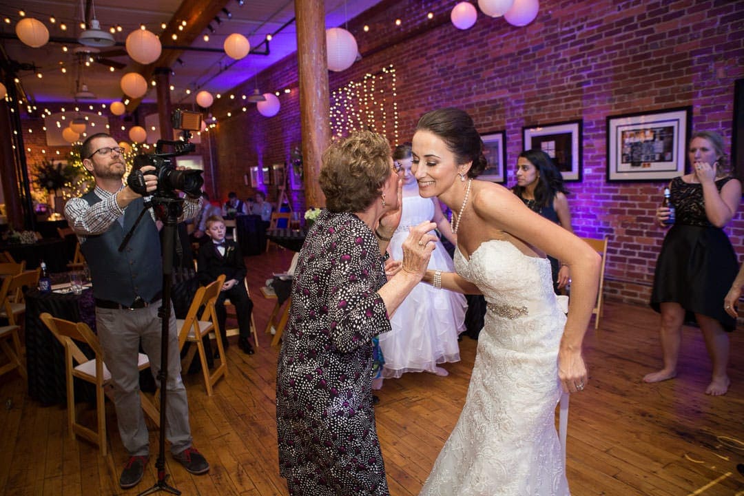 bride dances with family member at wedding reception